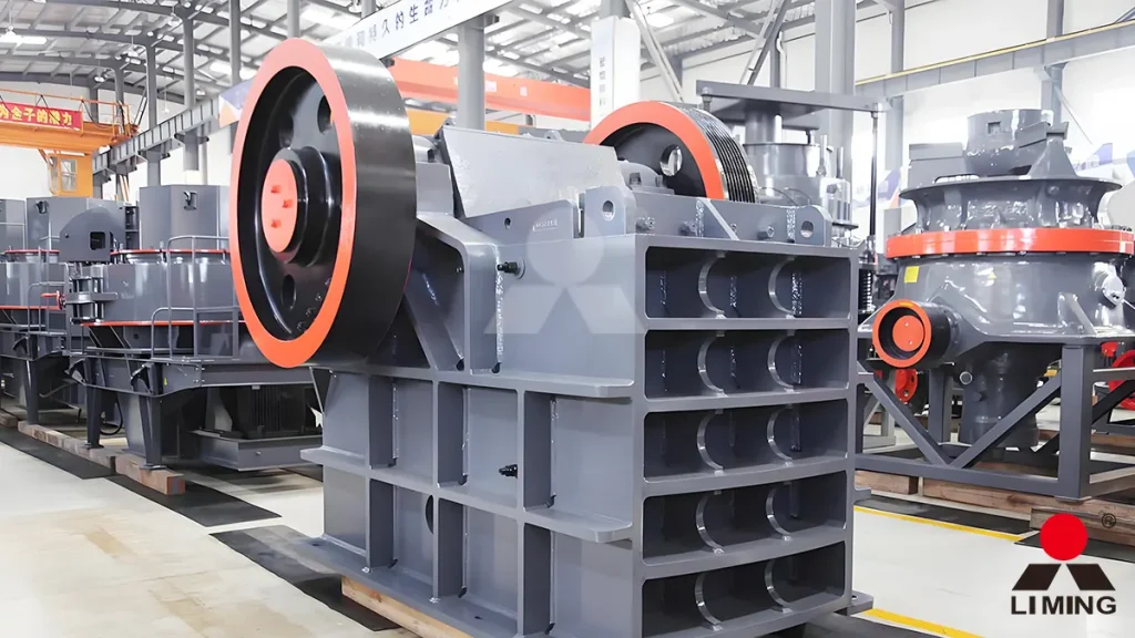 PE series jaw crusher handling large dark basalt rocks at a primary crushing station